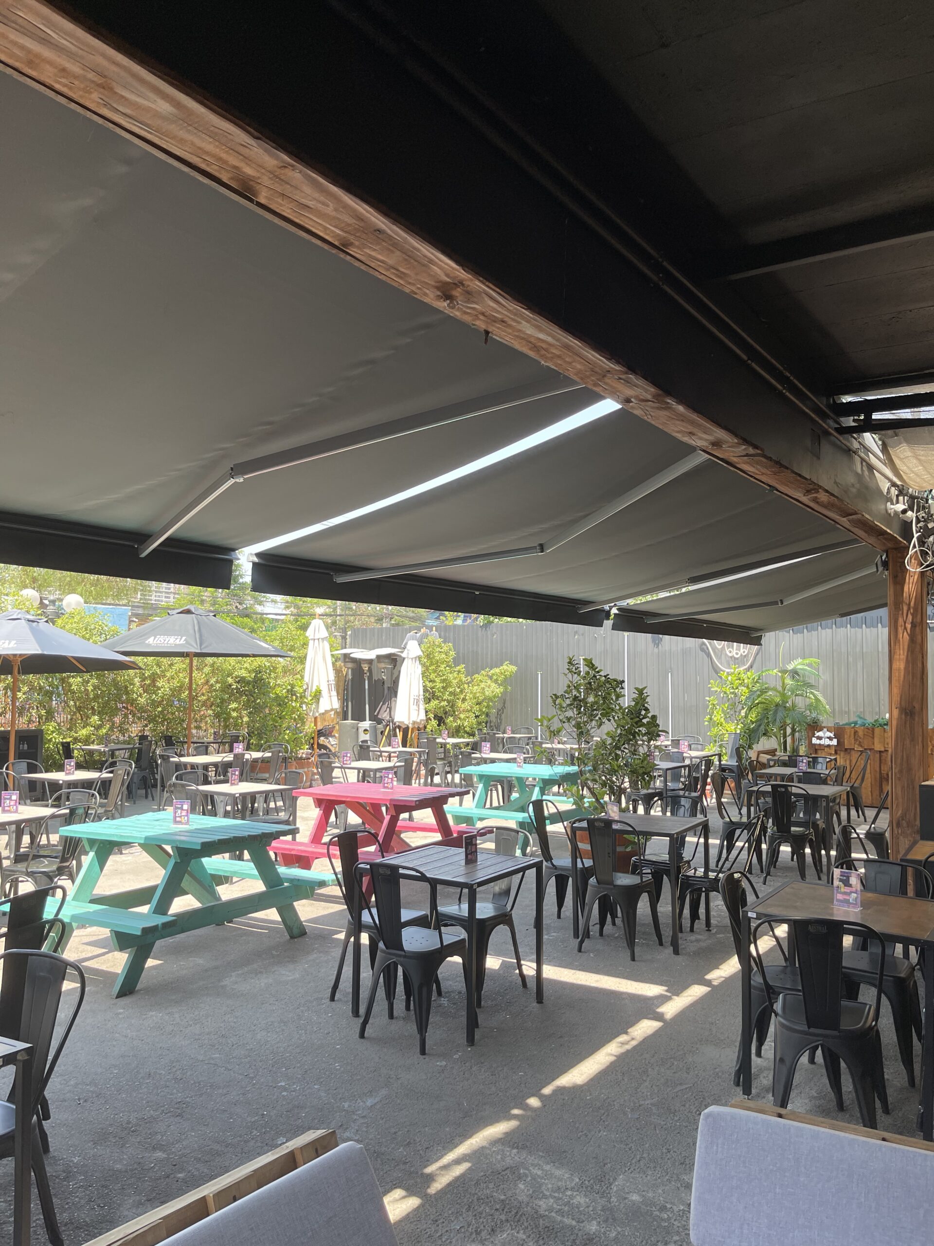 Terraza de departamento moderna con cierre de cristal plegable, amoblada con sofá. Terraza protegida del clima.