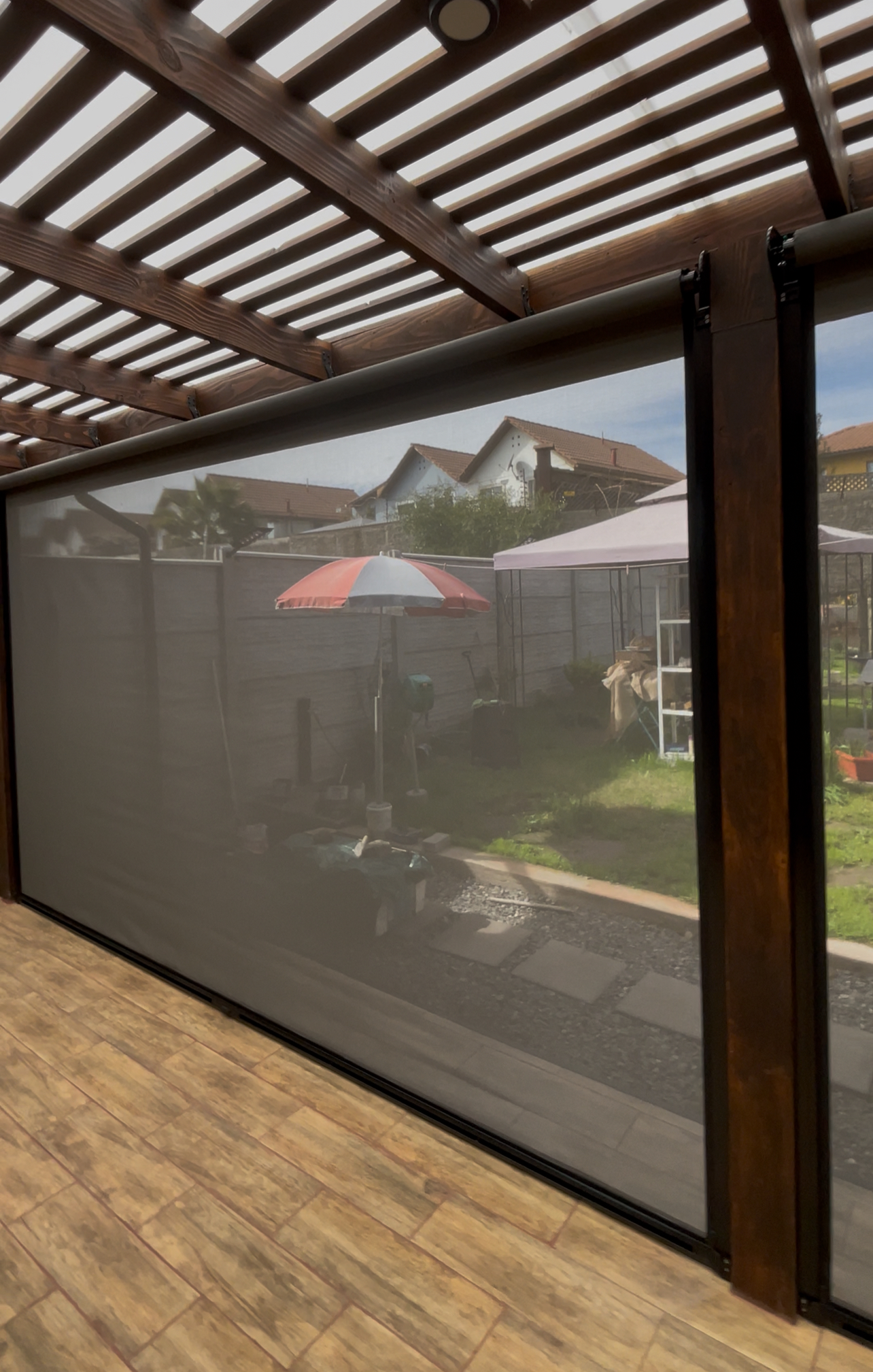 Terraza de departamento moderna con cierre de cristal plegable, amoblada con sofá. Terraza protegida del clima.